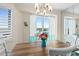 Bright dining room with water views, features a wood table and white chairs at 3737 S Atlantic Ave # 504, Daytona Beach, FL 32118