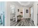 Bright hallway with wood-look tile flooring and access to bedrooms and bath at 3737 S Atlantic Ave # 504, Daytona Beach, FL 32118