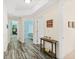 Bright hallway with wood-look floors, leading to bedrooms at 3737 S Atlantic Ave # 504, Daytona Beach, FL 32118