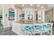 Open kitchen with large island, granite counters, and teal barstools at 3737 S Atlantic Ave # 504, Daytona Beach, FL 32118