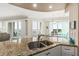 Kitchen with granite counters, double sink, and water views at 3737 S Atlantic Ave # 504, Daytona Beach, FL 32118