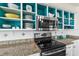Bright kitchen with granite countertops, stainless steel appliances, and teal accents at 3737 S Atlantic Ave # 504, Daytona Beach, FL 32118