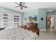 Main bedroom with king bed, TV, and access to balcony at 3737 S Atlantic Ave # 504, Daytona Beach, FL 32118