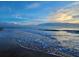 Serene ocean view at sunrise, showcasing calm waves at 3737 S Atlantic Ave # 504, Daytona Beach, FL 32118