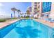 Inviting community pool with lounge chairs and beach access at 3737 S Atlantic Ave # 504, Daytona Beach, FL 32118