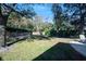 Spacious backyard with mature trees, a privacy fence, and lush greenery, offering a serene outdoor retreat at 396 Muddy Creek Ln, Ormond Beach, FL 32174