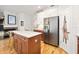 Kitchen featuring stainless fridge, island with seating and view of fireplace at 396 Muddy Creek Ln, Ormond Beach, FL 32174