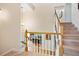 Staircase showcasing wood railing and trim, with a view into the dining area at 396 Muddy Creek Ln, Ormond Beach, FL 32174