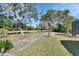 Private backyard with mature trees and lush lawn at 428 Hightower Dr, Debary, FL 32713