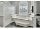 Bathroom with soaking tub, walk-in shower, and window with shutters at 428 Hightower Dr, Debary, FL 32713