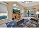 Gathering room with large TV, comfortable seating and view to backyard at 428 Hightower Dr, Debary, FL 32713