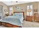 Spacious main bedroom with a large bed and wood furniture at 428 Hightower Dr, Debary, FL 32713