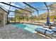 Relaxing screened pool area with lounge chairs and patio at 428 Hightower Dr, Debary, FL 32713