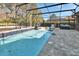 Relaxing screened-in pool area, featuring tiled pool and stone patio, perfect for outdoor living at 428 Hightower Dr, Debary, FL 32713