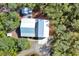 Overhead view of house and detached garage nestled in the woods at 4525 Owls Nest Ct, De Leon Springs, FL 32130
