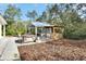 Backyard view featuring an outdoor kitchen, bar, hot tub and seating at 4525 Owls Nest Ct, De Leon Springs, FL 32130