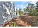 Backyard view featuring the home, covered porch, hot tub and outdoor kitchen at 4525 Owls Nest Ct, De Leon Springs, FL 32130