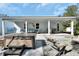 Backyard space with covered porch, hot tub, and comfortable outdoor seating at 4525 Owls Nest Ct, De Leon Springs, FL 32130