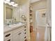 Modern bathroom with a sink, decorative mirror and ample storage space at 4525 Owls Nest Ct, De Leon Springs, FL 32130