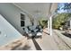 Inviting covered patio with comfortable seating and views of the surrounding greenery at 4525 Owls Nest Ct, De Leon Springs, FL 32130