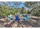 Scenic view of the outdoor fire pit area surrounded by beautiful foliage and comfortable Adirondack chairs at 4525 Owls Nest Ct, De Leon Springs, FL 32130