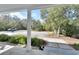View from the front porch overlooking a gravel driveway and lush landscaping at 4525 Owls Nest Ct, De Leon Springs, FL 32130
