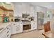 Updated kitchen features stainless steel appliances, custom cabinetry, and natural wood accents at 4525 Owls Nest Ct, De Leon Springs, FL 32130