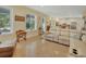 Well-lit open living space with a comfortable sofa, a large window, and a seamless connection to the modern kitchen at 4525 Owls Nest Ct, De Leon Springs, FL 32130