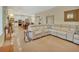Open-concept living space with seamless flow to the kitchen, featuring a modern sofa and ample natural light at 4525 Owls Nest Ct, De Leon Springs, FL 32130