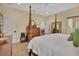 Comfortable main bedroom with natural light, a four-poster bed, and view to dining area at 4525 Owls Nest Ct, De Leon Springs, FL 32130