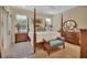 Four-poster bed, bench, and vintage dresser in spacious bedroom with neutral color palette at 4525 Owls Nest Ct, De Leon Springs, FL 32130