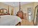 Spacious main bedroom with white walls, wood furnishings, and great natural light at 4525 Owls Nest Ct, De Leon Springs, FL 32130