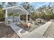 Wonderful backyard featuring an outdoor kitchen, bar, hot tub, and Adirondack chairs at 4525 Owls Nest Ct, De Leon Springs, FL 32130