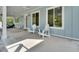Inviting covered porch featuring comfortable seating, ceiling fans, and ample space for relaxation with views of the landscape at 4525 Owls Nest Ct, De Leon Springs, FL 32130