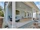 Inviting covered porch with comfortable seating, perfect for relaxing outdoors at 4525 Owls Nest Ct, De Leon Springs, FL 32130