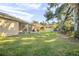 Spacious backyard with grassy area and mature trees at 555 Morgan Wood Dr, Deland, FL 32724