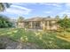 Large backyard featuring a screened porch and grassy area at 555 Morgan Wood Dr, Deland, FL 32724