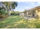 Spacious backyard with screened patio and lush lawn at 555 Morgan Wood Dr, Deland, FL 32724