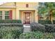 Front entry with a brown door and neatly trimmed shrubs at 555 Morgan Wood Dr, Deland, FL 32724