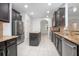 Open kitchen with dark cabinets, granite counters, and stainless steel appliances at 555 Morgan Wood Dr, Deland, FL 32724