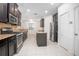 Open kitchen with dark cabinets, granite counters, and stainless steel appliances at 555 Morgan Wood Dr, Deland, FL 32724