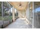 Relaxing screened porch with ceiling fan and backyard access at 555 Morgan Wood Dr, Deland, FL 32724