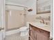Bathroom featuring white tile, a shower with a curtain, and a wooden vanity at 641 Hartley Ave, Deltona, FL 32725