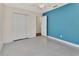 Bedroom with blue accent wall, closet, neutral walls and tiled floors at 641 Hartley Ave, Deltona, FL 32725