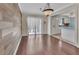 Elegant dining area with hardwood floors, a modern light fixture, and a view of the kitchen at 641 Hartley Ave, Deltona, FL 32725