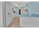 Bright kitchen featuring white appliances, a breakfast bar, and blue accent walls for a refreshing feel at 641 Hartley Ave, Deltona, FL 32725