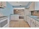 Bright eat-in kitchen featuring wood-look backsplash, blue countertops, tile floors, and bar seating at 641 Hartley Ave, Deltona, FL 32725