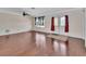 Large living room with hardwood floors, double doors, a window, and ample space for furniture arrangements at 641 Hartley Ave, Deltona, FL 32725