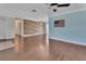 Bright living area featuring a wood accent wall, hardwood floors, and a ceiling fan for added comfort at 641 Hartley Ave, Deltona, FL 32725