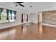 Open living space with hardwood floors, double doors, and a large window providing natural light at 641 Hartley Ave, Deltona, FL 32725